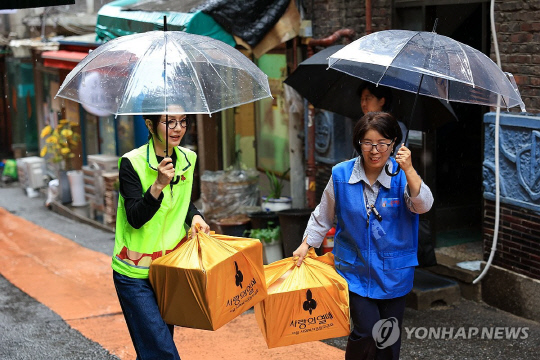 윤석열 대통령의 부인 김건희 여사가 추석 명절을 앞두고 13일 서울 중구 동자동 쪽방촌을 찾아 추석 선물을 전달하고 있다.<연합뉴스>
